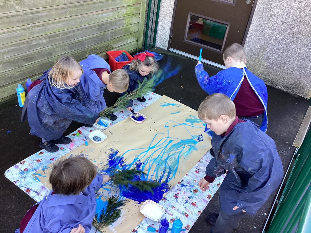 Children painting outdoors with colourful paints